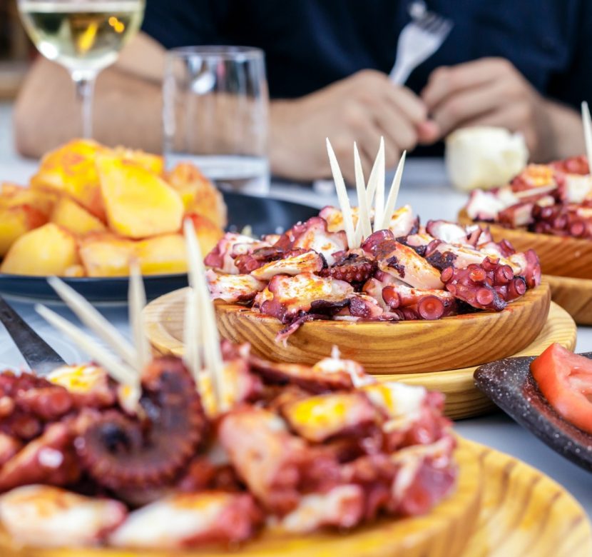 people-eating-pulpo-a-la-gallega-with-potatoes-galician-octopus-picture-id922562780